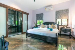 a bedroom with a large bed in a room at Siam Jewel - Private pool villa in Bang Tao in Bang Tao Beach +29 photos