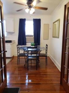 a dining room table with chairs and a ceiling fan at Cozy 2 bedroom 1 bath unit in Anderson