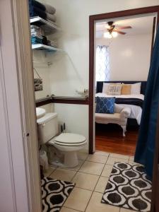 a bathroom with a toilet and a bedroom with a bed at Cozy 2 bedroom 1 bath unit in Anderson