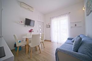 a living room with a blue couch and a table at Apartment Toni with spacious terrace in Postira