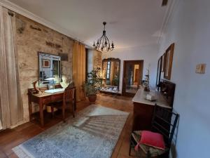 a living room with a wooden table and a desk at Casa a Pedreira Rias Baixas in Cuntis