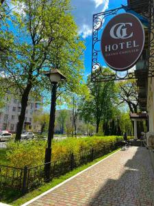 a sign for a hotel next to a sidewalk at Grand Christer Hotel in Kyiv