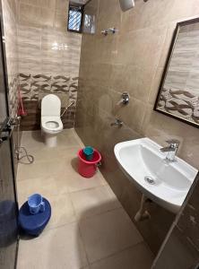 a bathroom with a sink and a toilet at Kaashi Flora (2BHK - Ground Floor) in Varanasi