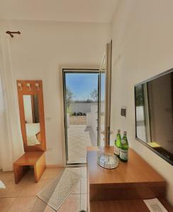 a living room with a table and a sliding glass door at Agriturismo Panacea in Santa Cesarea Terme