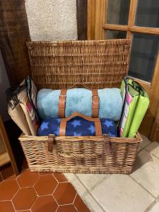 a wicker basket sitting on the floor with books at La Foret in La Châtre-Langlin