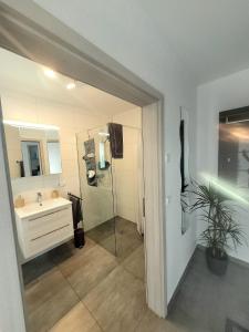 a bathroom with a sink and a mirror at Ferienwohnung Hanek in Annweiler am Trifels
