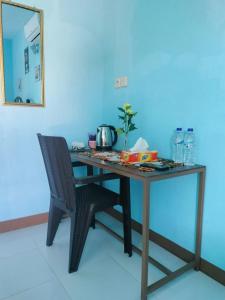 Cowang Dereng Home Stay في لابوان باجو: طاولة خشبية مع كرسي ومرآة