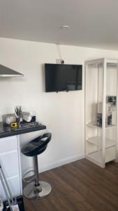 a kitchen with a counter and a stool in a room at The Annexe Bedford in Bedford