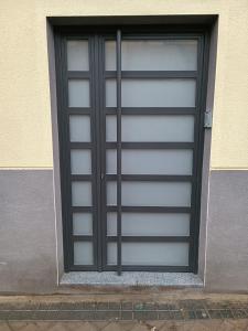 a metal garage door with black trim on a building at Apartamento pacifico a in Madrid