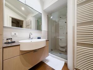 ein Bad mit einem Waschbecken und einer Glasdusche in der Unterkunft Realkasa Belfiore Apartment in Bologna