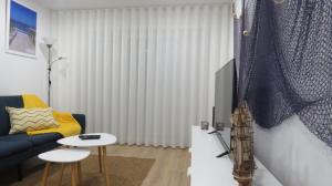 a living room with a couch and a table at Afife & Ínsua Beach Apartment in Viana do Castelo