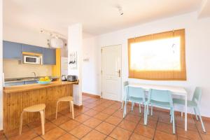 a kitchen with a table and chairs in a room at Garden house with two terraces in Corralejo