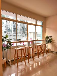a room with a table and chairs and a large window at BAOBAB in Patong Beach