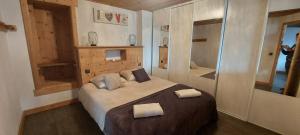 a bedroom with a large bed with two towels on it at Les Hauts de Sallanches in Sallanches