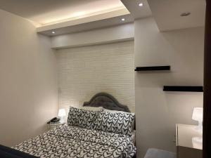 a bedroom with a bed in a room at The Pearl - Venice Luxury Residences McKinley in Manila