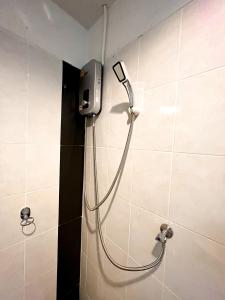 a shower in a bathroom with a shower head on a wall at BAOBAB in Patong Beach