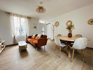 a living room with a table and a couch at La ferme de la brutellette in Woignarue