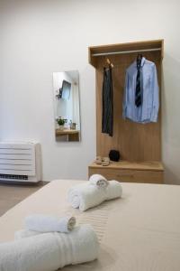 a bedroom with two towels sitting on a bed at Tarsis Guest House in Baunei