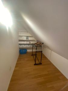 a attic room with a white ceiling and wooden floors at Minergie in Rickenbach