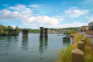 a river with a group of pillars in the water at The Lake House in Plymouth