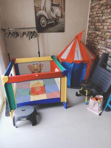a toy room with a play set and a tent at Loft chez Valy et Hervé in Charleville-Mézières