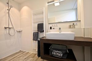 a bathroom with a sink and a shower at Villa Petersen Ankerplatz 3 in Wangerooge +13 photos