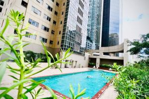a swimming pool in a building with tall buildings at BGC 1BR Near SM Aura & Restaurant with Free Wi-Fi in Manila