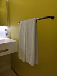 a white towel hanging on a towel rack in a bathroom at Comfy Room In Genting Highlands in Genting Highlands