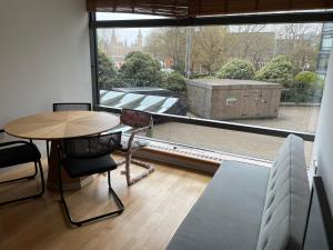 a room with a table and chairs and a large window at Big Ben Inn in London