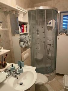 a bathroom with a shower and a sink and a toilet at Apartmani PENAVIĆ in Makarska +15 photos