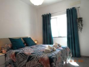 Cama ou camas em um quarto em Villa Andorinha