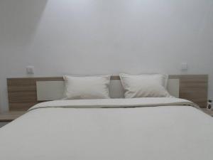 Cama ou camas em um quarto em Villa Andorinha