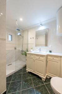 a bathroom with a sink and a shower and a toilet at "San Giacomo Square Apt." in the heart of old town in Corfu