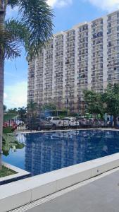 a large apartment building with a large swimming pool at Condo Stay at Saekyung Looc in Lo-oc