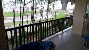 a balcony with a view of a road and trees at Cox's Bazar Surf Club Resort & Cafe in Cox's Bazar