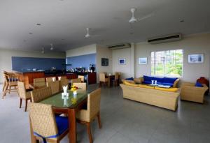 a living room with a table and chairs at Cox's Bazar Surf Club Resort & Cafe in Cox's Bazar