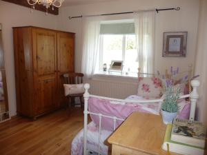 a bedroom with a bed and a window and a table at Hawthorn Cottage in Greencastle