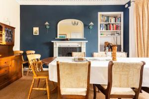 comedor con paredes azules, mesa y sillas en Lochinver en Crieff