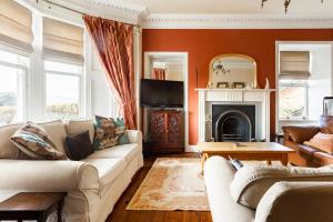Lochinver في كريف: غرفة معيشة مع أريكة ومدفأة