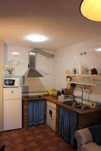 a kitchen with a sink and a stove top oven at Refugio del Chorrito in Grazalema