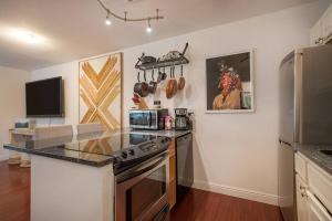 a kitchen with a stove and a counter top at The Creekside Retreat: Steps to all of Telluride in Telluride +5 photos