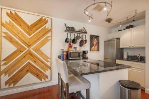 a kitchen with a counter with a wooden door at The Creekside Retreat: Steps to all of Telluride in Telluride