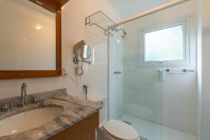 a bathroom with a sink and a toilet and a shower at Pousada Monte Felice Recanto da Lua in Gramado +47 photos
