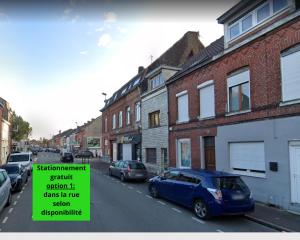 a blue car parked on a street with a sign on it at La cosy house Tourcoing in Tourcoing