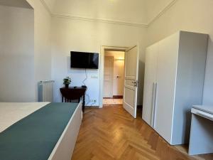 a bedroom with a bed and a flat screen tv at Appartamento “Al Duomo” Catania in Catania