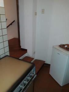 a kitchen with a stove and a small refrigerator at Appartamento Capanne in Capanne +11 photos