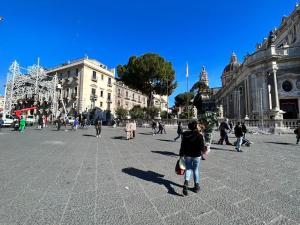 a group of people walking around a city square at Appartamento “Al Duomo” Catania in Catania