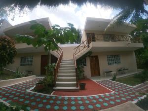 a house with a staircase in front of it at Villas Karalv in Bacalar