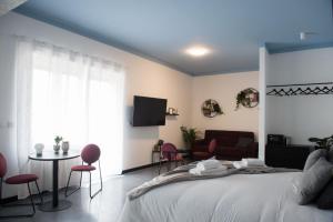 a bedroom with a bed and a couch and a table at Le Terrazze del Duca San Pietro Guesthouse in Rome