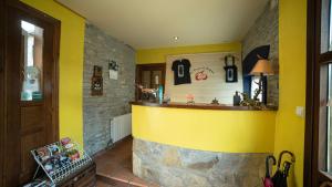 a kitchen with a yellow wall and a yellow counter at Hotel Rural Los Cerezos de Yanguas in Yanguas